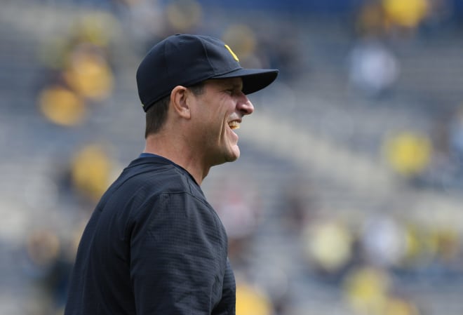 Michigan Wolverines football coach Jim Harbaugh smiling.