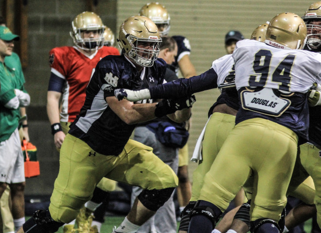 Alex Bars' (left) shift back to tackle this spring is helping stabilize the offensive line.