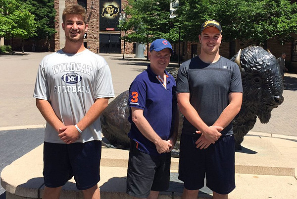 Chanz Russell (left) poses for a picture outside Folsom Field with Sebastian Olver and his dad.