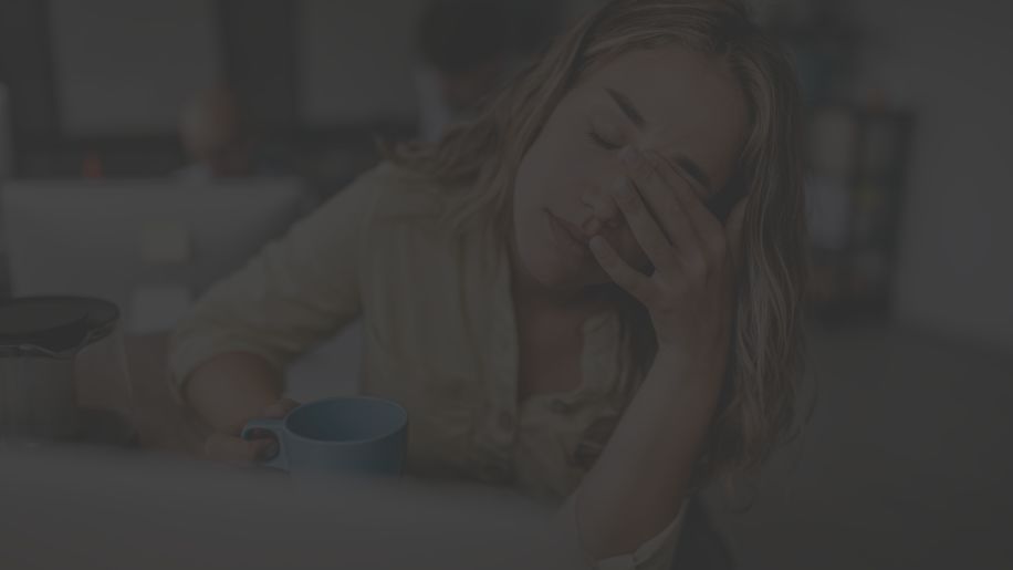 woman having a headache holding her head