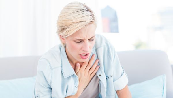 woman holding hand on chest