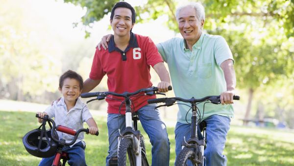 Grandfather son and grandson bike riding smiling to camera