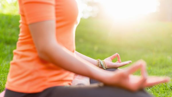 woman outside in easy yoga pose