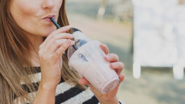 woman sipping a shake through a straw