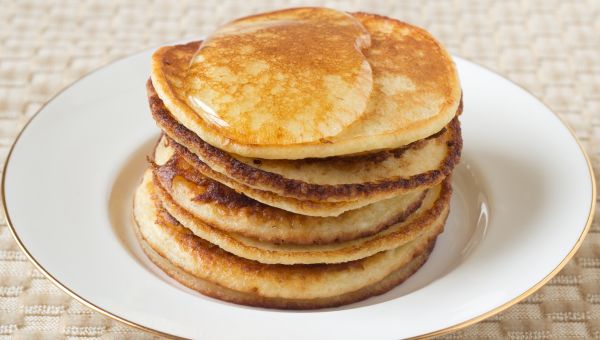 stack of pancakes with syrup on a plate