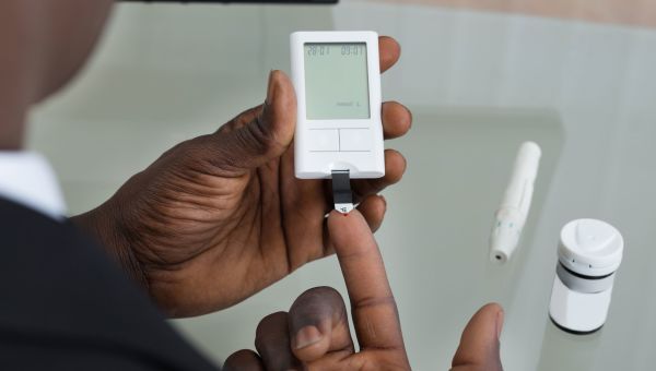 Man checking his blood glucose