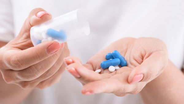 blue pills, hands, pill bottle, pills in hand
