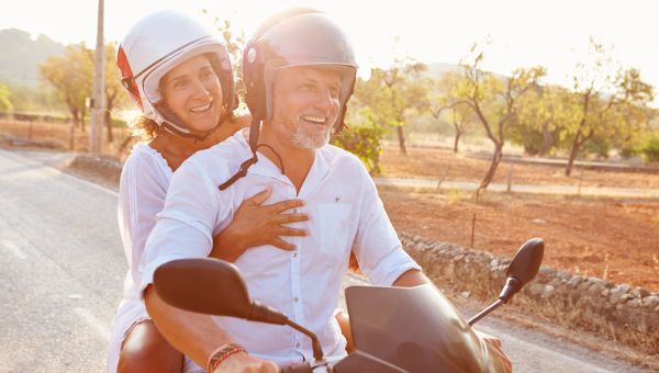 two mature people on moped, moped, driving