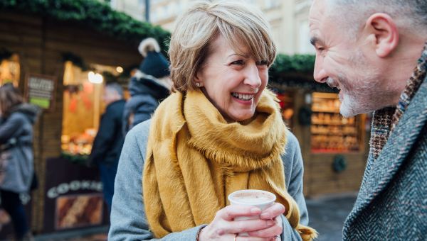 mature couple, coffee, cold, yellow scarf, outside, market
