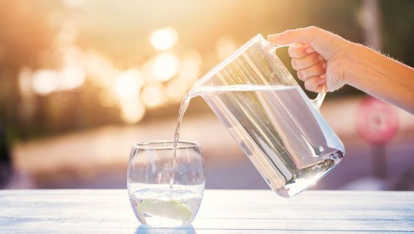 woman pouring a glass of clean water