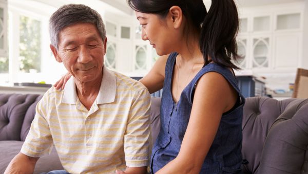 adult daughter comforting depressed father