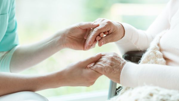 nurse holding a patient's hands