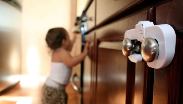 Toddler trying to open kitchen drawers