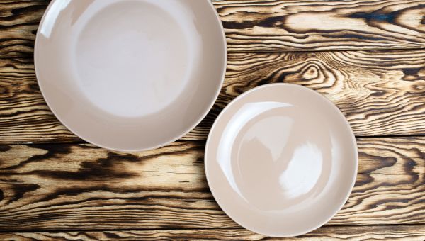 White plates on wooden table