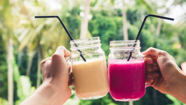 two fruit smoothies in mason jars