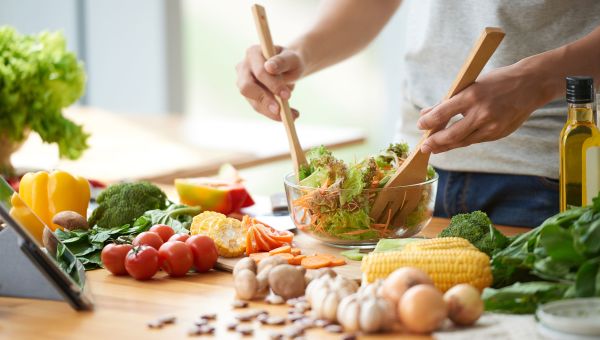 Person mixing a salad