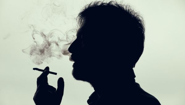 Silhouette of a man smoking