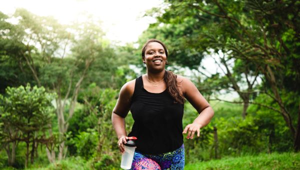 Woman in bright colorful shorts running outside 