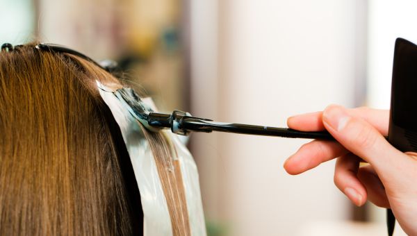 Woman using straight-iron on her hair