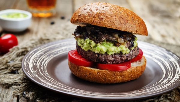 Black bean burger with guacamole, tomatoes.