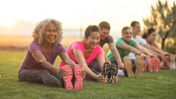 women stretching on grass