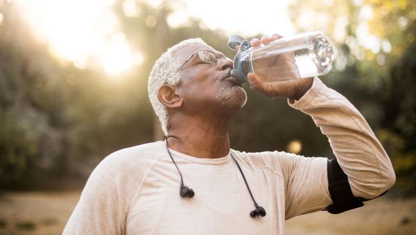 Senior man drinking water after a workout