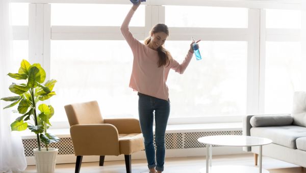 woman dancing while cleaning