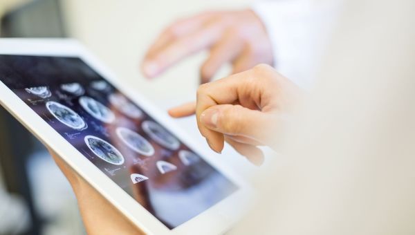 woman looking at mri on tablet