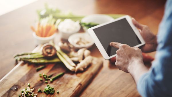 Woman looking up recipe on tablet