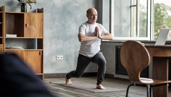 older man doing yoga