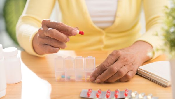 person using a pill box