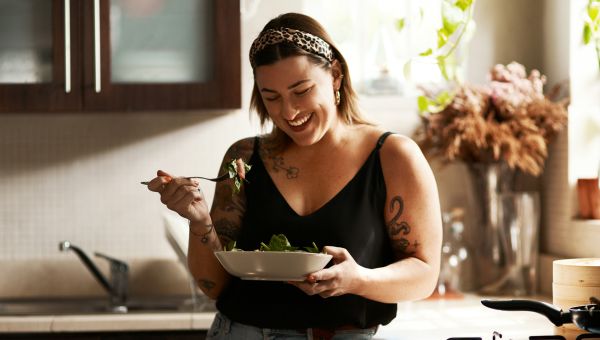 young person eating in the kitchen