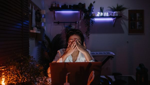 woman in front of laptop in dark room