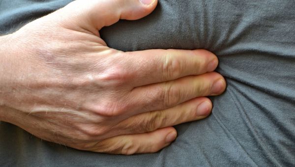 Man putting pressure on his abdomen