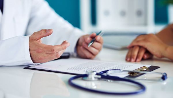 A doctor having a consultation with a patient about sterilization.