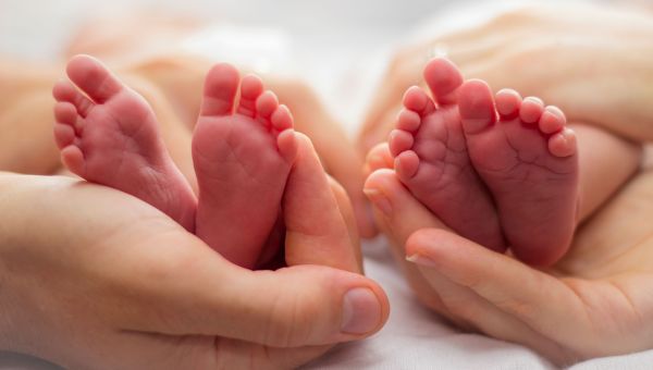 Two pairs of infant feet.