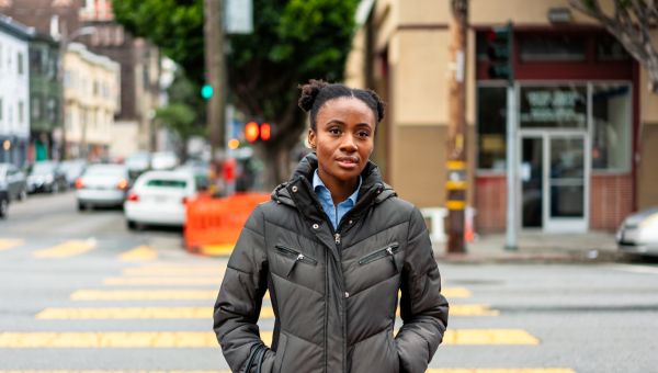 a young Black woman takes a walk in the city