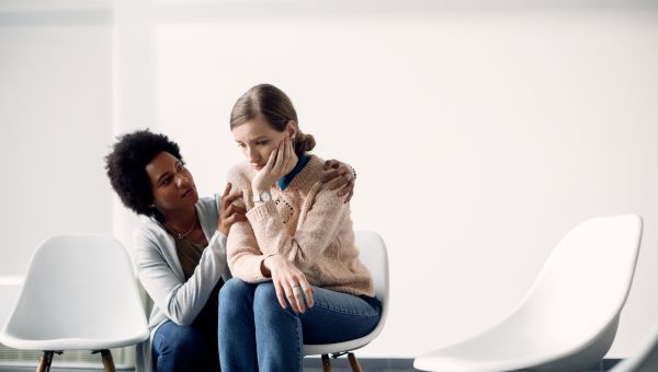 a therapist supports a distressed patient