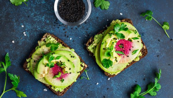 Two slices of avocado toast with black sesame seeds under 400 calories.