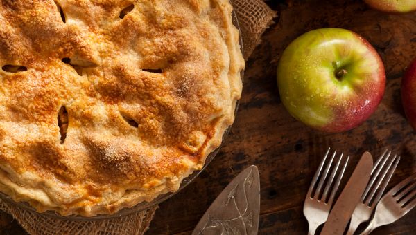 A healthy apple pie with a real apple on the side.