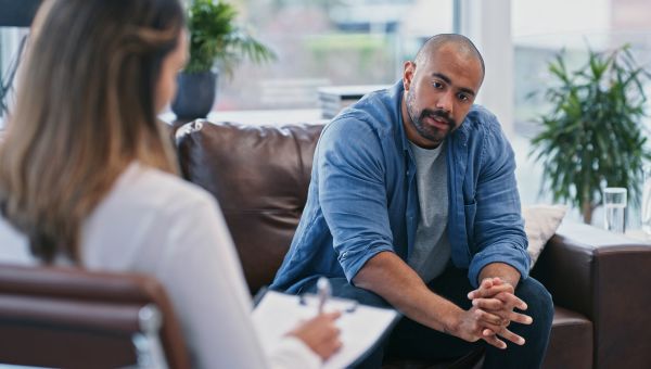 A man with bipolar disorder discusses his condition with a doctor