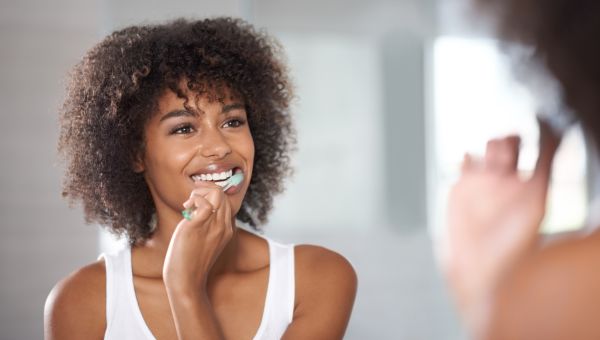 woman brushing teeth