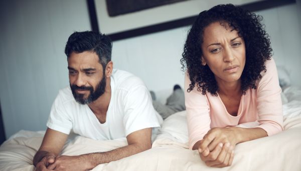 unhappy couple in bed