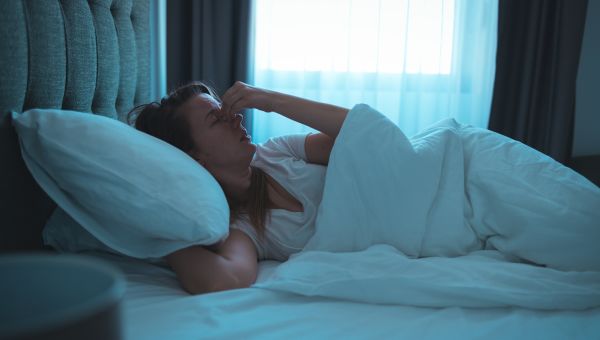 woman in bed upset she can't sleep