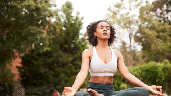 Black woman doing yoga pose, easy