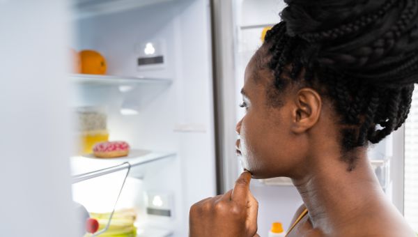 hungry woman looking in her fridge