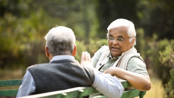 senior man listening to his friend talk