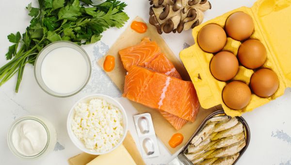 an array of healthy foods containing vitamin D, including eggs, salmon, sardines, dairy products, and mushrooms