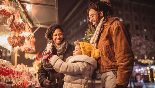 A happy family purchasing non-toxic gifts at a street vendor