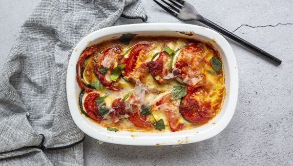 a healthy lasagna casserole made with fresh zucchini and tomato